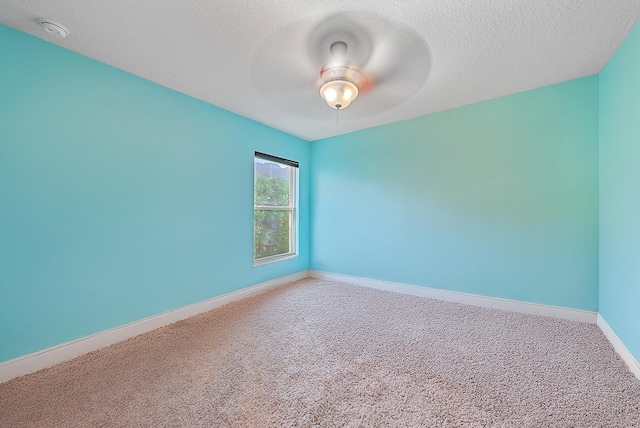 carpeted empty room with a textured ceiling and ceiling fan