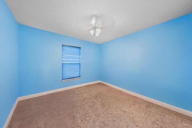 spare room with a textured ceiling and carpet flooring