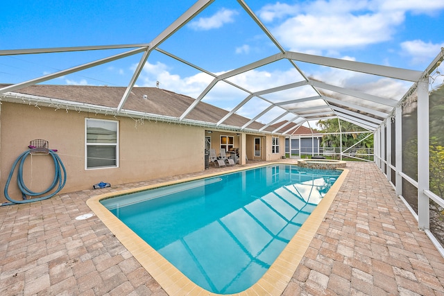 view of pool featuring a lanai and a patio