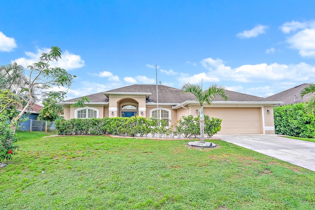 single story home with a garage and a front lawn