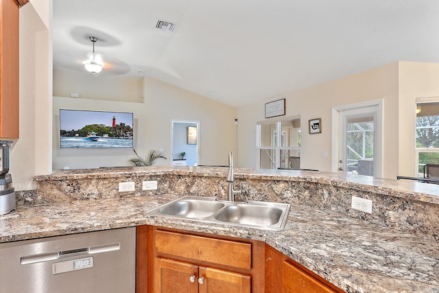 kitchen with dishwasher, sink, and vaulted ceiling