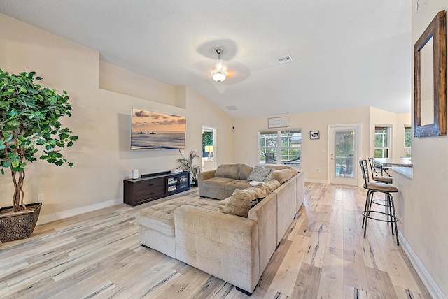 living room featuring ceiling fan, lofted ceiling, and light hardwood / wood-style floors