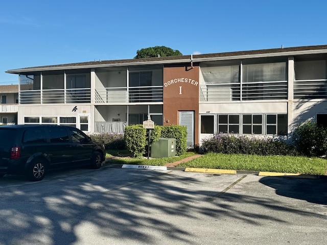 206 Dorchester Unit I, West Palm Beach, FL 33417 - view of building exterior featuring uncovered parking