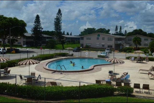 206 Dorchester Unit I, West Palm Beach, FL 33417 - community pool featuring fence and a patio area