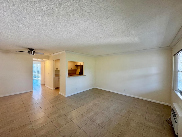 tiled spare room featuring ornamental molding, a wall unit AC, a textured ceiling, and ceiling fan