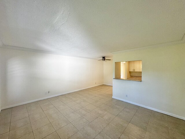 206 Dorchester Unit I, West Palm Beach, FL 33417 - unfurnished room featuring a textured ceiling, baseboards, ceiling fan, and ornamental molding