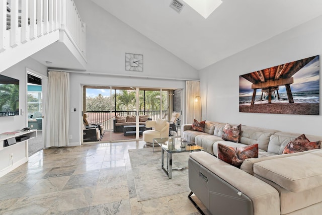 living room with high vaulted ceiling