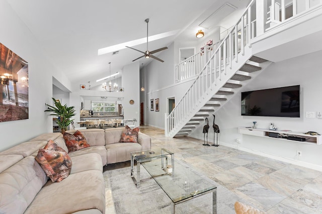 living room featuring ceiling fan with notable chandelier and high vaulted ceiling