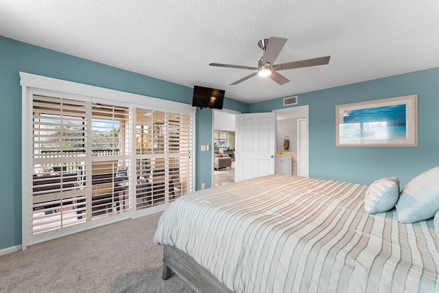 bedroom featuring carpet flooring, a textured ceiling, and ceiling fan