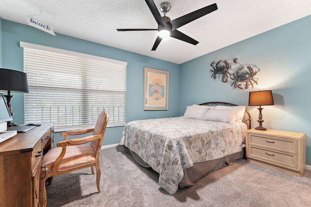 carpeted bedroom with ceiling fan and a textured ceiling