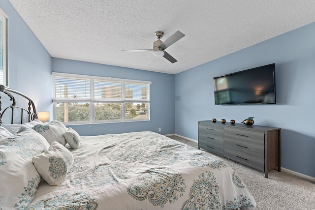 carpeted bedroom with a textured ceiling and ceiling fan