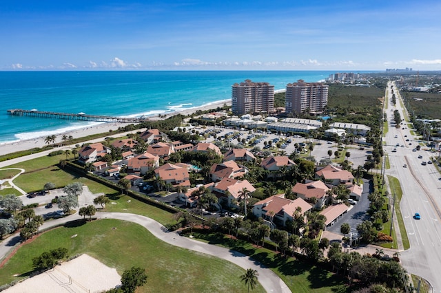 birds eye view of property featuring a beach view and a water view