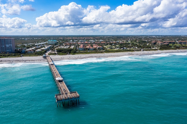 birds eye view of property with a beach view and a water view