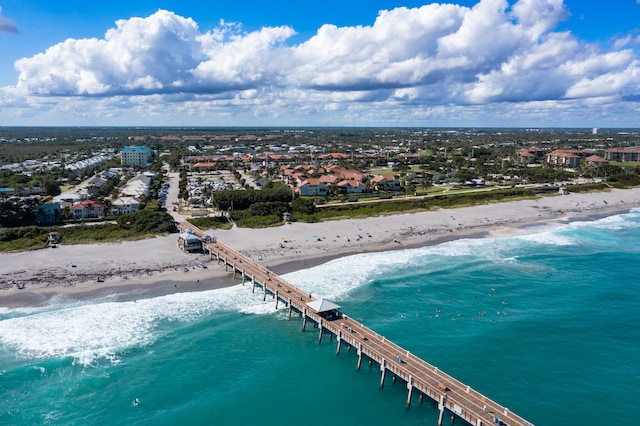 birds eye view of property with a water view and a view of the beach