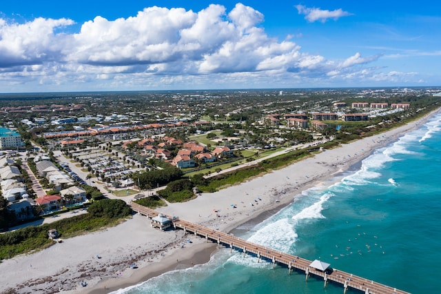 drone / aerial view with a beach view and a water view