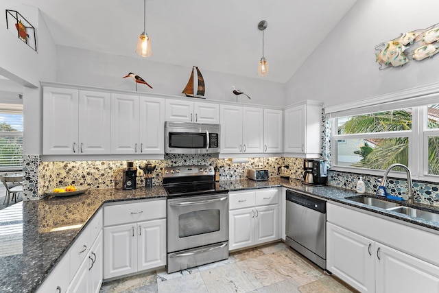 kitchen featuring a wealth of natural light, sink, white cabinets, and stainless steel appliances