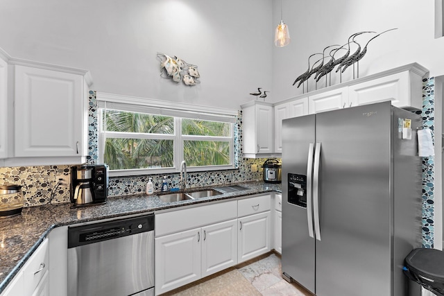 kitchen featuring white cabinets, decorative backsplash, sink, and appliances with stainless steel finishes