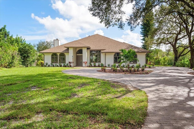 mediterranean / spanish house featuring a front yard