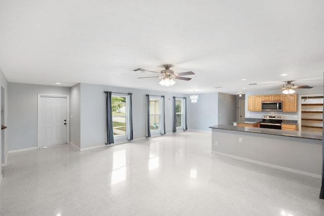 1413 SE San Sovina Ter, Port Saint Lucie, FL 34952 - unfurnished living room featuring ceiling fan, baseboards, recessed lighting, and a chandelier