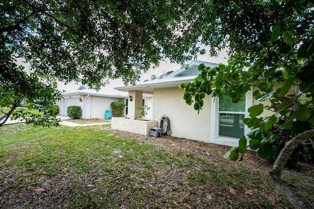 1413 SE San Sovina Ter, Port Saint Lucie, FL 34952 - back of house with stucco siding and a garage