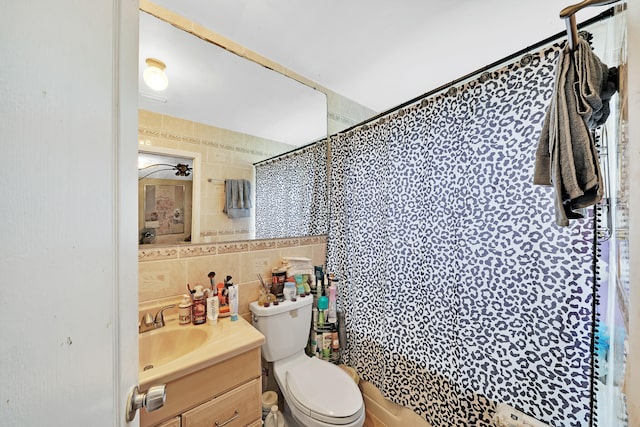 bathroom with vanity, curtained shower, and tile walls