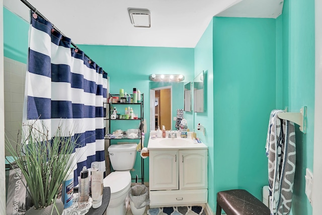 bathroom with vanity, toilet, and walk in shower