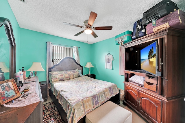 bedroom with a textured ceiling and ceiling fan