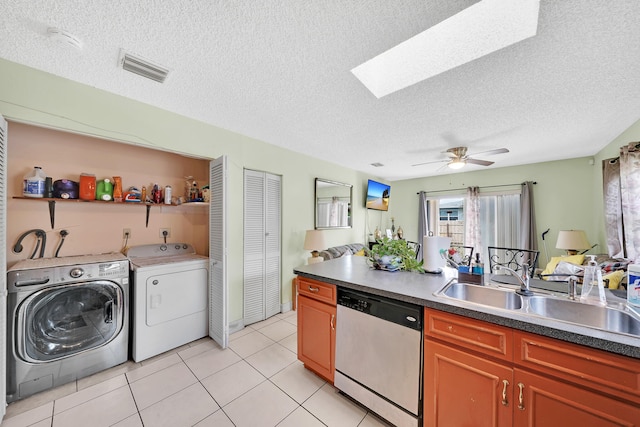 kitchen with a skylight, ceiling fan, dishwasher, and a textured ceiling