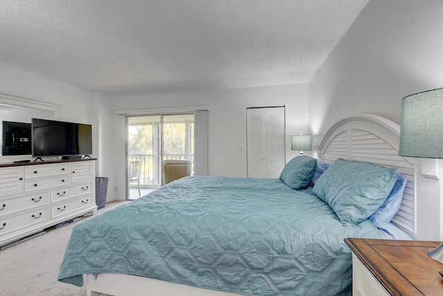 bedroom featuring a textured ceiling, light carpet, and access to outside