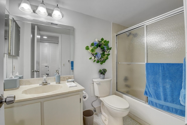 full bathroom with vanity, tile patterned floors, shower / bath combination with glass door, and toilet