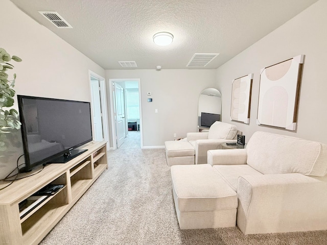 carpeted living room with a textured ceiling