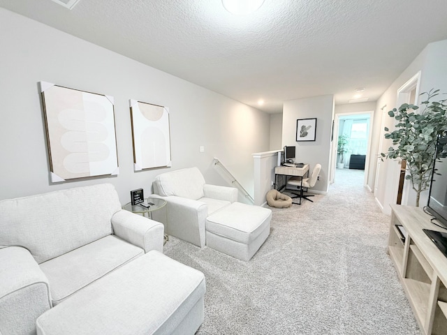 living room with carpet and a textured ceiling