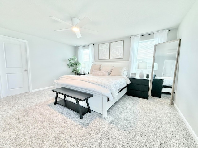 carpeted bedroom with multiple windows and ceiling fan