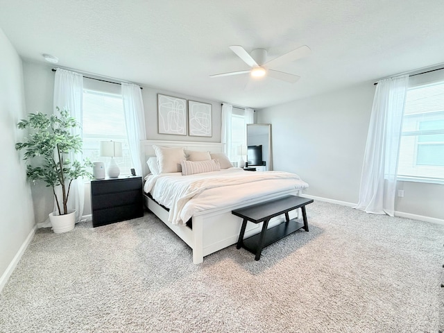 carpeted bedroom featuring a textured ceiling and ceiling fan