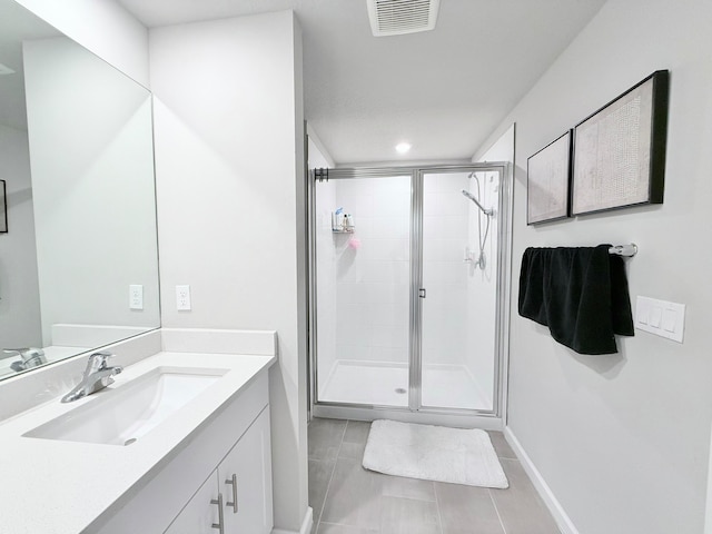 bathroom with vanity, tile patterned floors, and an enclosed shower