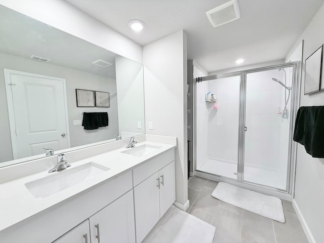 bathroom with tile patterned flooring, vanity, and an enclosed shower