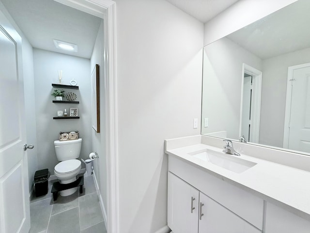 bathroom with tile patterned floors, vanity, and toilet