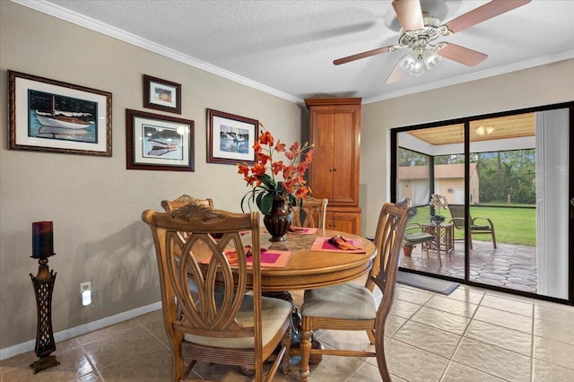 tiled dining area with ceiling fan, crown molding, and a textured ceiling