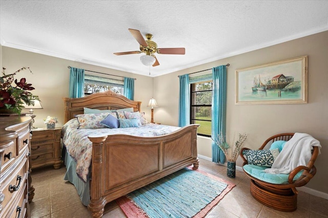 bedroom featuring light tile patterned floors, a textured ceiling, ceiling fan, and ornamental molding