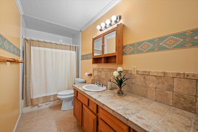 bathroom with tile patterned flooring, a textured ceiling, toilet, vanity, and ornamental molding