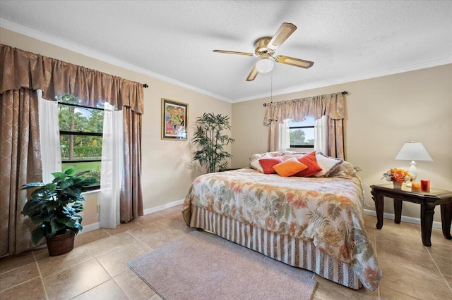 tiled bedroom with a textured ceiling, ceiling fan, and ornamental molding