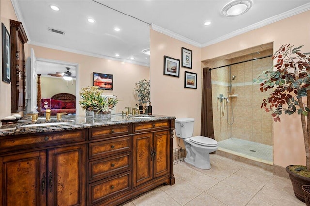 bathroom featuring tile patterned floors, a tile shower, and crown molding