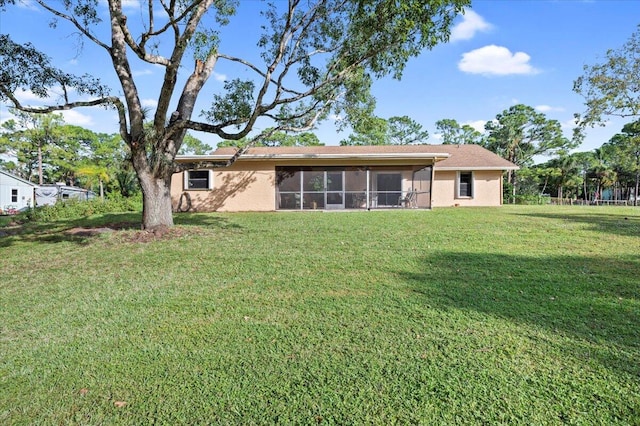 back of property featuring a yard