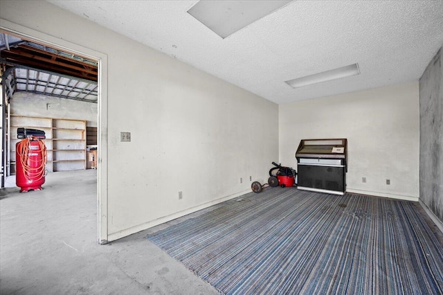 interior space with a textured ceiling and concrete floors