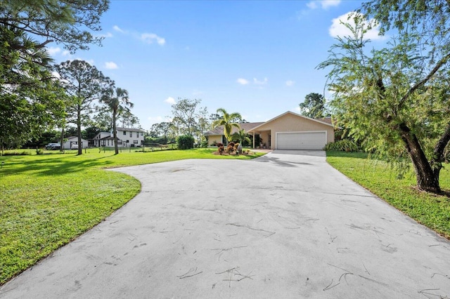 ranch-style home with a garage and a front lawn