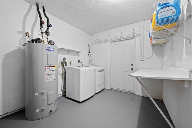 laundry area featuring water heater, washer and dryer, and a textured ceiling