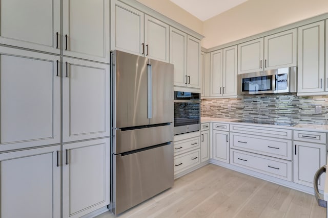 kitchen featuring tasteful backsplash, stainless steel appliances, and light hardwood / wood-style floors