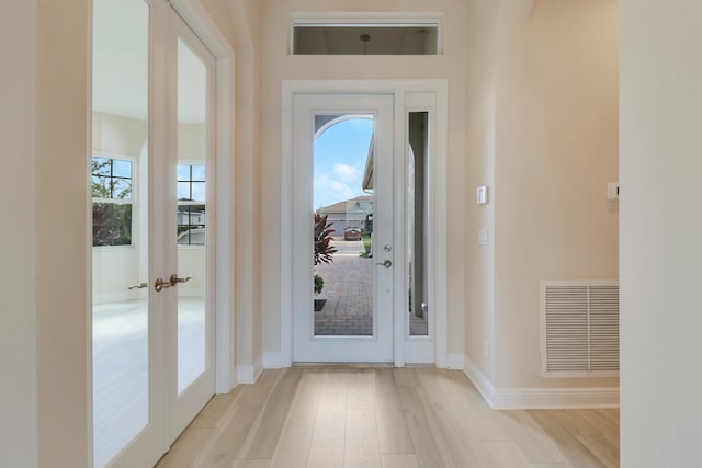 doorway featuring french doors and light hardwood / wood-style flooring