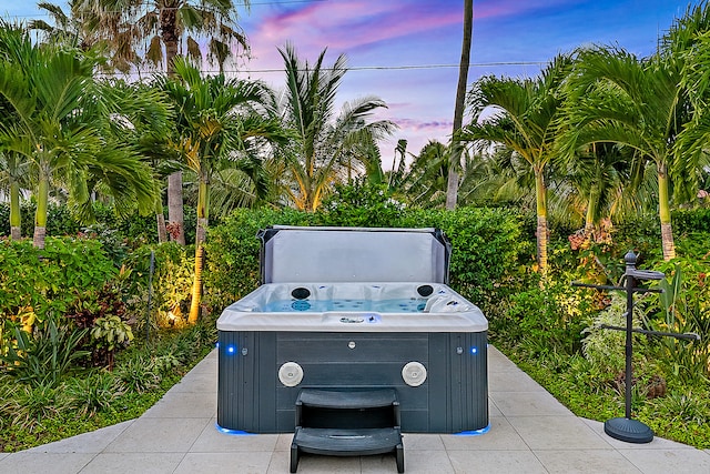 exterior details featuring tile patterned flooring and a hot tub