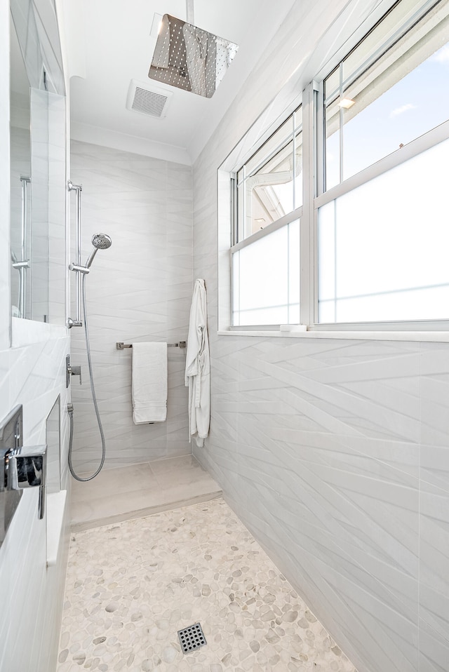 bathroom with tiled shower